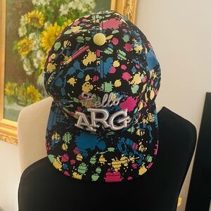 🎉Vibrant playful splatter print. Features 'Hello ARG' text on the front cap